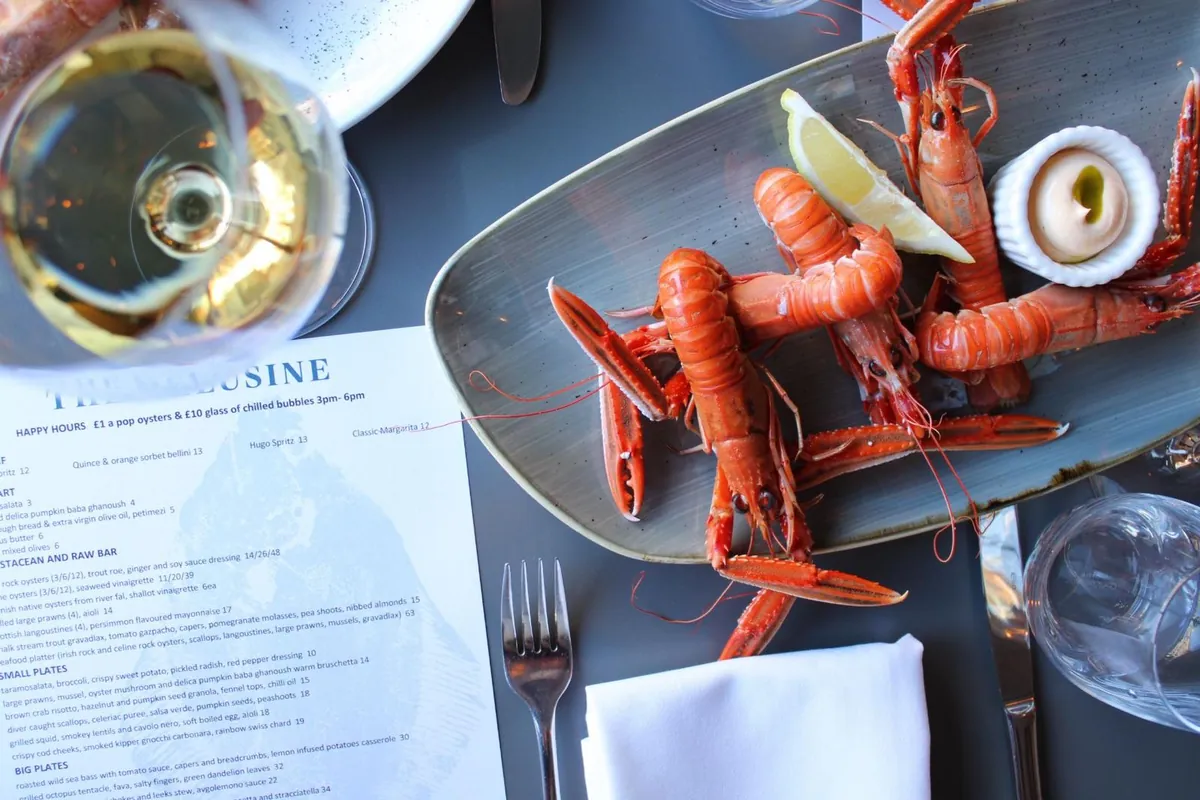 Langoustines and wine on a table at The Melusine